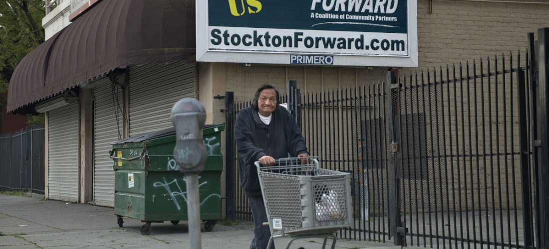Feb. 7, 2013 - Stockton, CA, USA - A man walks with his shopping cart near a Stockton Forward billboard in downtown Stockton, California, on February 7, 2013. (Credit Image: © Hector Amezcua/TNS/ZUMAPRESS.com)